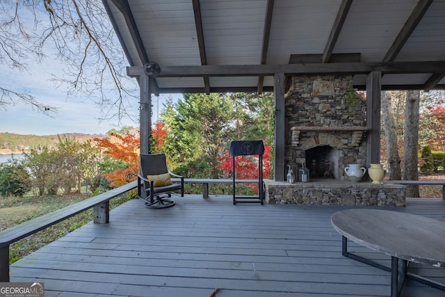 deck featuring an outdoor stone fireplace