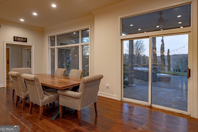 dining room with crown molding, ceiling fan, and dark wood-type flooring