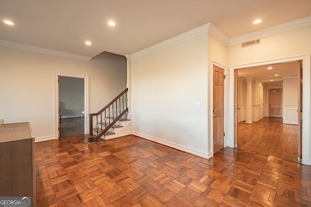 spare room featuring dark parquet floors and ornamental molding