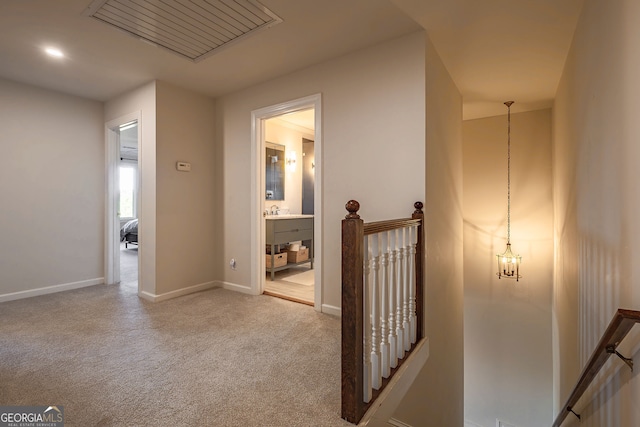 hallway featuring light colored carpet and sink