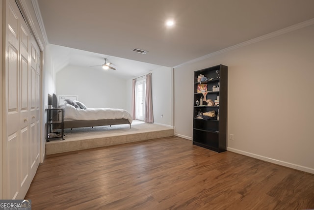 unfurnished bedroom with crown molding, a closet, and dark hardwood / wood-style floors