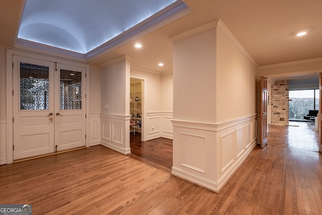 foyer entrance featuring light hardwood / wood-style floors and ornamental molding