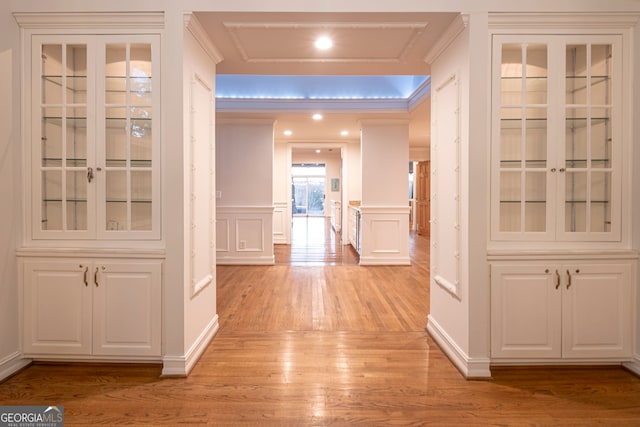 corridor with crown molding and light hardwood / wood-style flooring