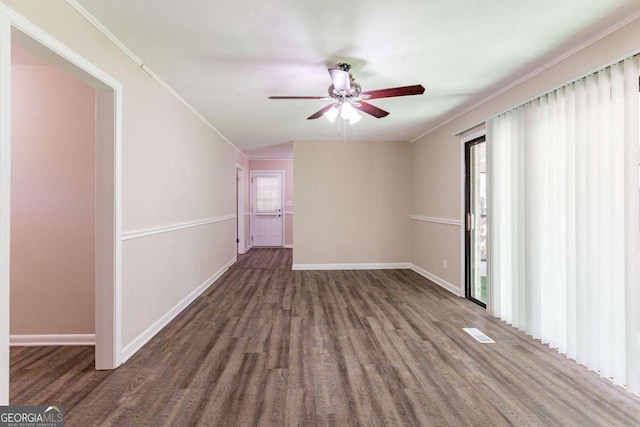 empty room with dark hardwood / wood-style flooring, ceiling fan, and ornamental molding