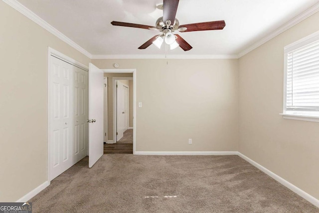 unfurnished bedroom featuring light carpet, ceiling fan, and crown molding