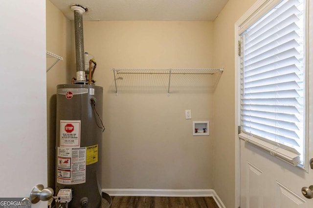 clothes washing area featuring hookup for a washing machine, dark hardwood / wood-style flooring, and gas water heater