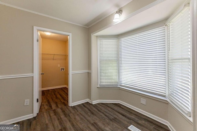 unfurnished room with crown molding and dark wood-type flooring