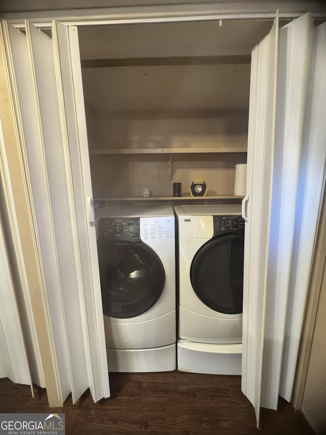 washroom with separate washer and dryer and dark hardwood / wood-style flooring