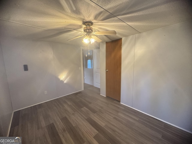 unfurnished room featuring dark hardwood / wood-style flooring and ceiling fan