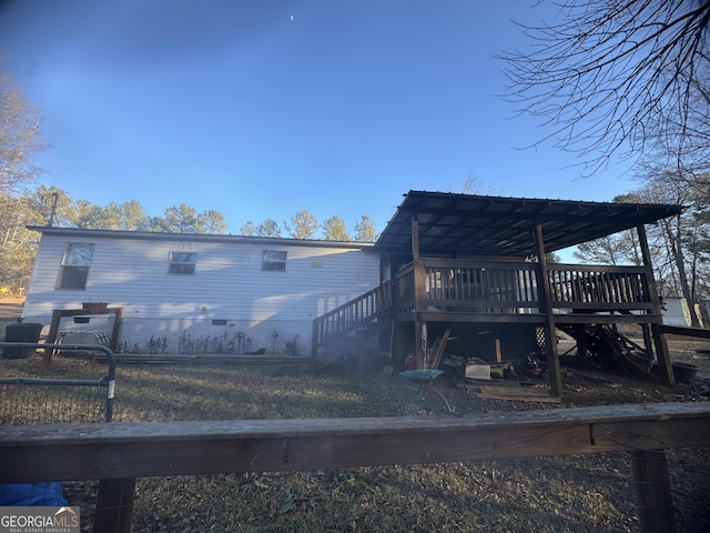 rear view of property featuring a deck