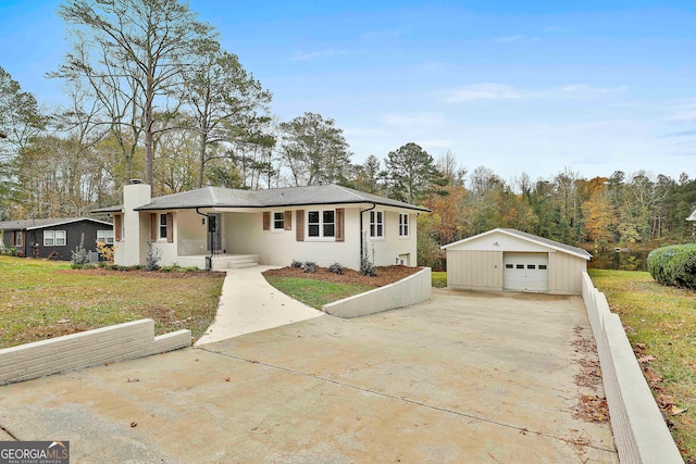 ranch-style home with a porch, a garage, an outbuilding, and a front yard