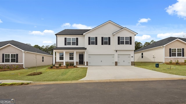 view of front of home with a front lawn and a garage