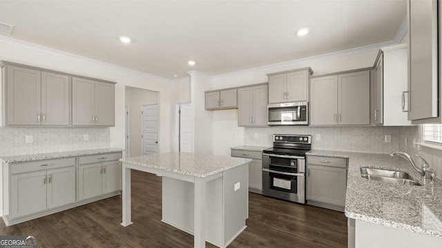 kitchen featuring gray cabinetry, a sink, and appliances with stainless steel finishes