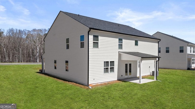 rear view of property with a patio area, cooling unit, and a lawn