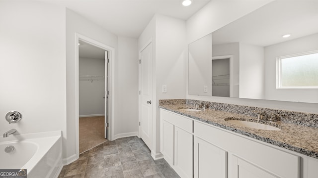 bathroom featuring vanity and a bath