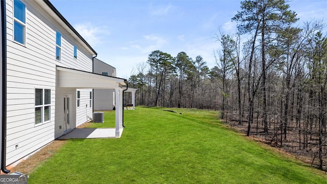 view of yard featuring central air condition unit and a patio area
