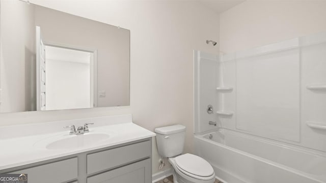 bathroom featuring toilet, vanity, and  shower combination