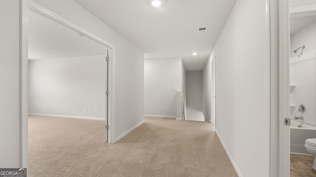 hallway with light carpet