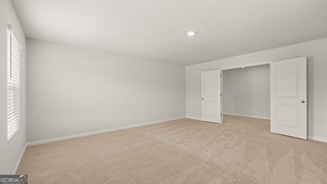 unfurnished bedroom with light colored carpet