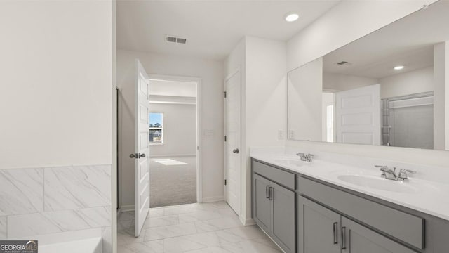 bathroom with double vanity, recessed lighting, visible vents, marble finish floor, and a sink