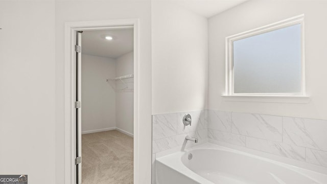 full bath with a bath and a spacious closet