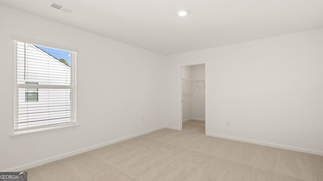 unfurnished room featuring light carpet, baseboards, visible vents, and recessed lighting