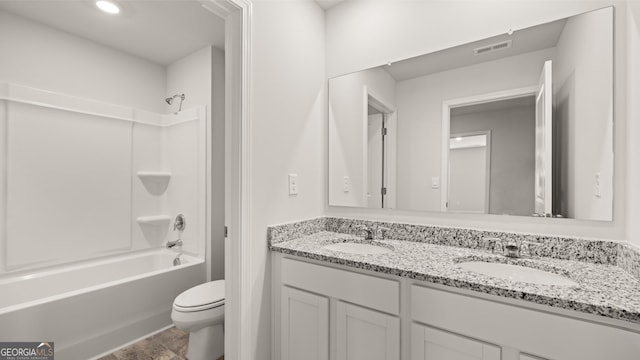 full bathroom featuring toilet, vanity, and washtub / shower combination