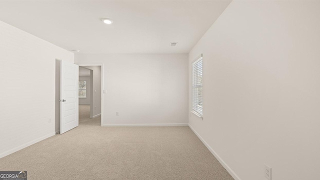 interior space with light carpet, baseboards, visible vents, and recessed lighting