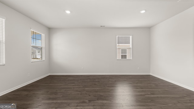 spare room featuring dark wood-type flooring