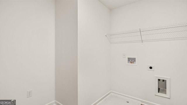 clothes washing area featuring laundry area, baseboards, hookup for a washing machine, and electric dryer hookup