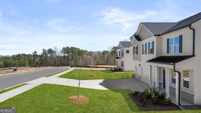 view of yard with driveway and an attached garage