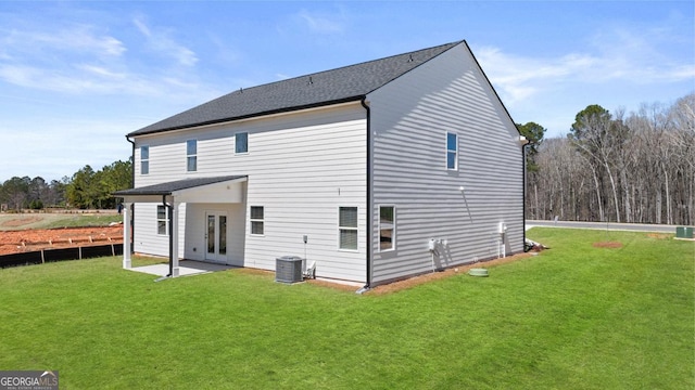 back of house featuring a yard, central AC unit, and a patio