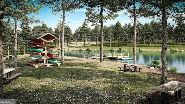 view of property's community featuring a water view, a boat dock, and a lawn