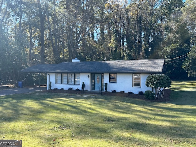 ranch-style home with a front yard and a carport