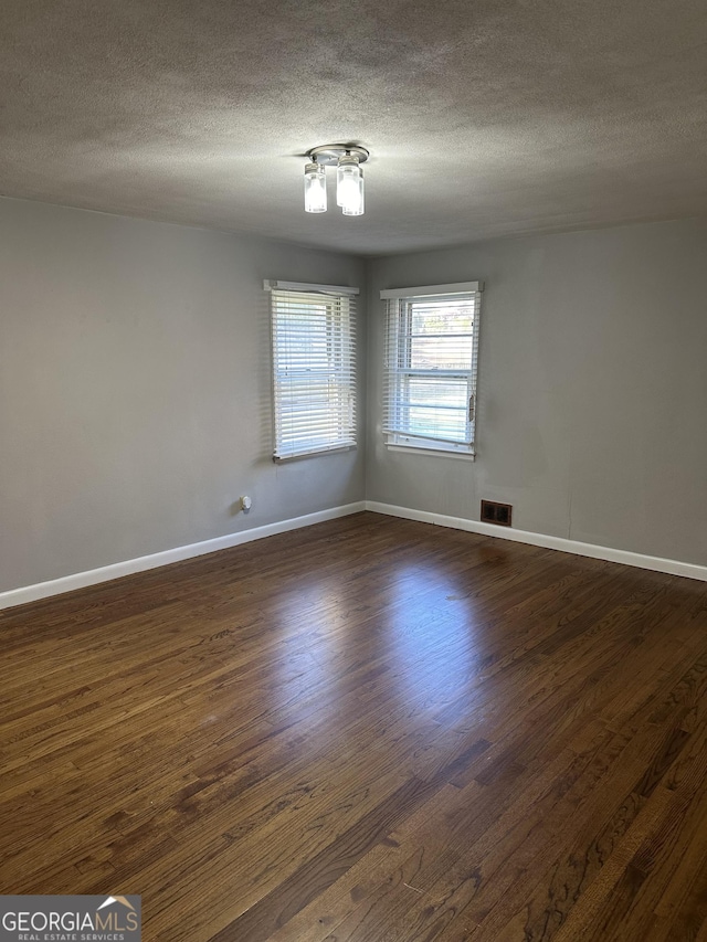 50 Pine Valley Dr, Athens, GA 30606 - spare room featuring dark wood-style floors, visible vents, baseboards, and a textured ceiling