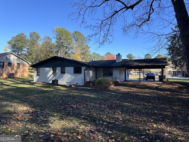50 Pine Valley Dr, Athens, GA 30606 - view of front of house featuring an attached carport, a front yard, brick siding, and a chimney