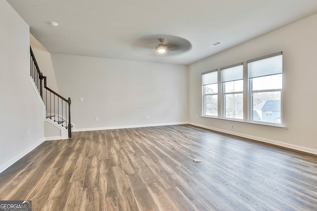 unfurnished room featuring dark hardwood / wood-style floors and ceiling fan