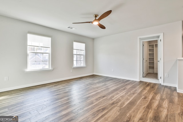 unfurnished room featuring ceiling fan and hardwood / wood-style flooring