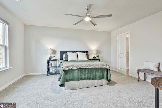 carpeted bedroom with multiple windows and ceiling fan