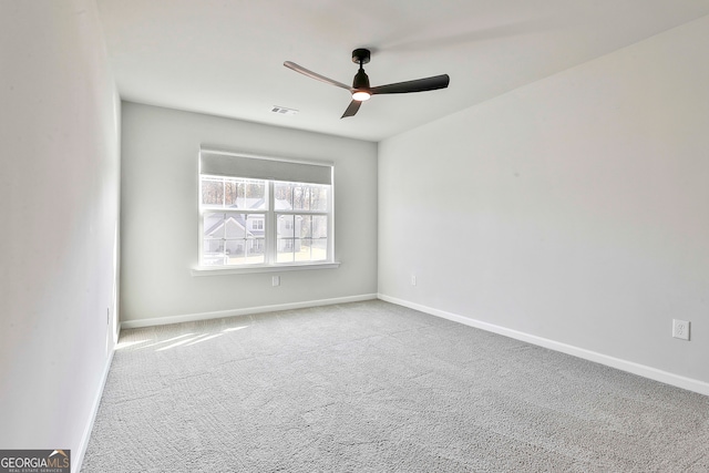 spare room featuring light carpet and ceiling fan