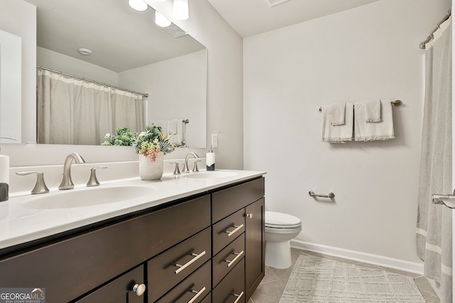 bathroom with tile patterned floors, vanity, and toilet