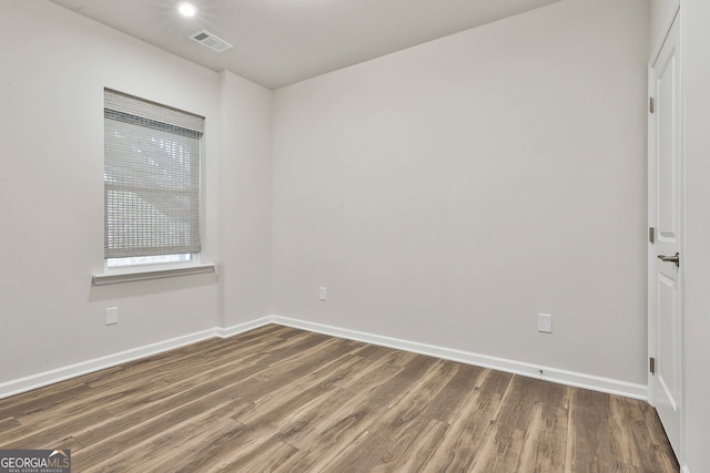 unfurnished room with dark wood-type flooring