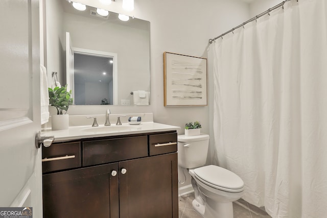 bathroom featuring tile patterned floors, vanity, and toilet