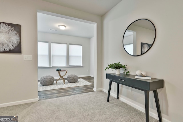 foyer entrance featuring carpet