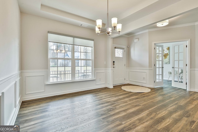 foyer featuring plenty of natural light, dark hardwood / wood-style floors, and french doors