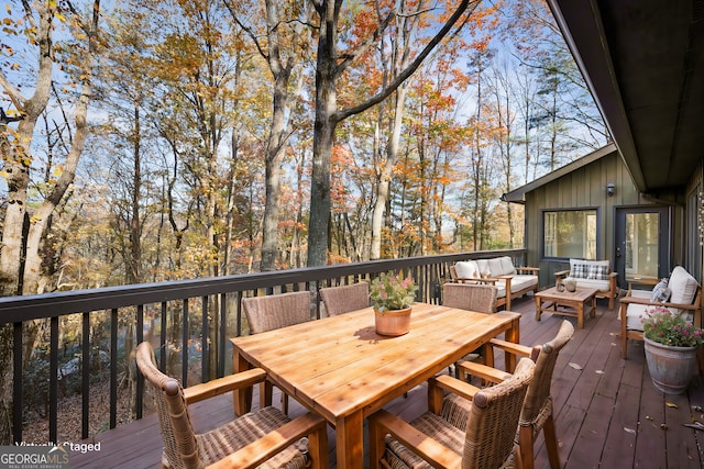 wooden deck featuring outdoor dining space and an outdoor hangout area