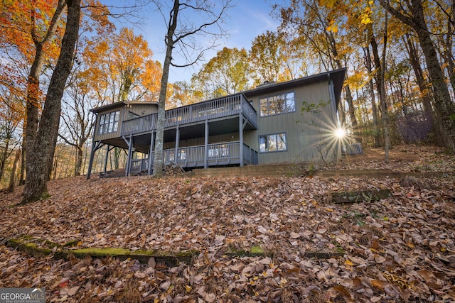 rear view of house featuring a wooden deck