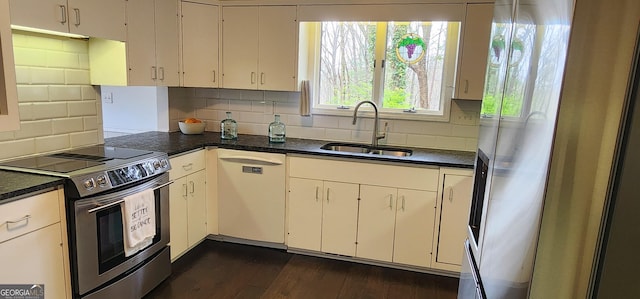 kitchen featuring dark wood-type flooring, a sink, white cabinetry, and tasteful backsplash