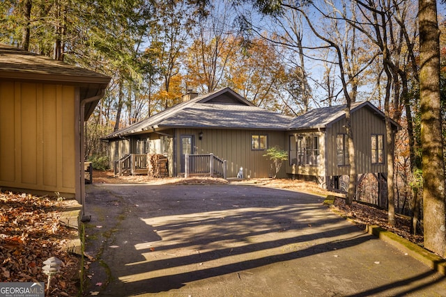 view of front of home with driveway and a shingled roof