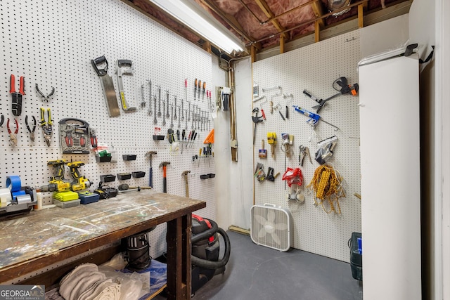 misc room featuring a workshop area and concrete flooring